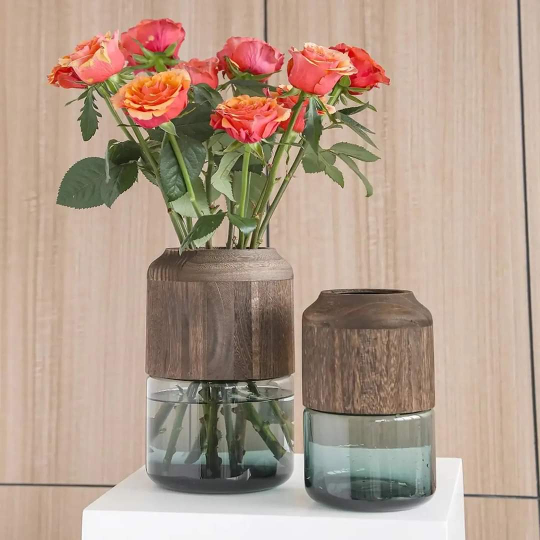 A tall clear glass flower vase featuring a professional removable wooden accent piece at the base.