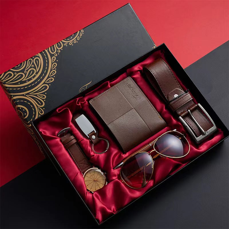 A Men's gift set containing a watch, wallet, belt, pen, keyholder, and sunglasses, presented in a box with a red and black interior.