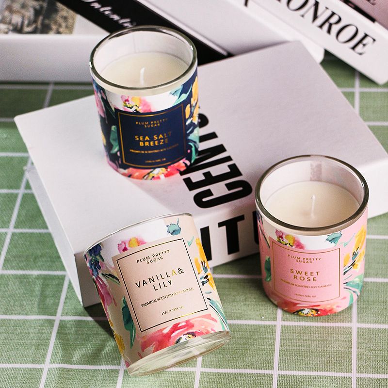 A set of botanical aromatherapy scented candles in glass jars featuring jasmine and rose fragrances.