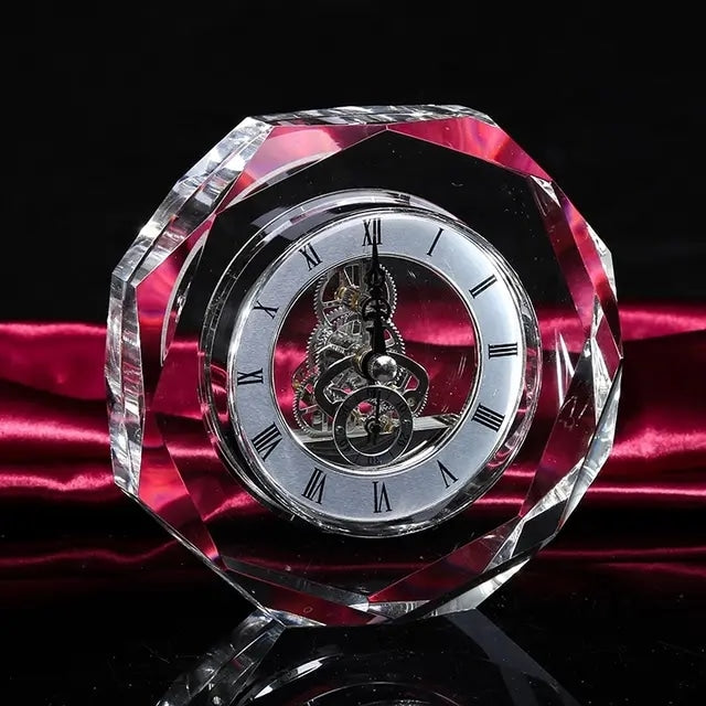 A crystal desk clock with a roman numeral clock face