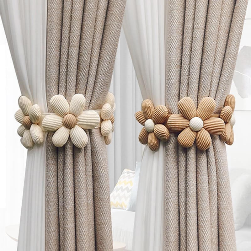 A decorative single piece flower shaped curtain tieback