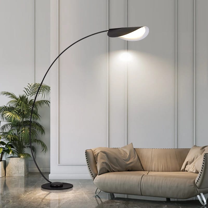 A black arc floor lamp casting downward light