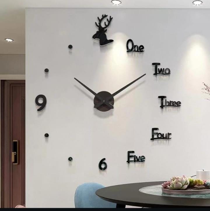 A black 3D frameless wall clock with a deer head at the twelve o'clock position and a mix of numbers and written words.