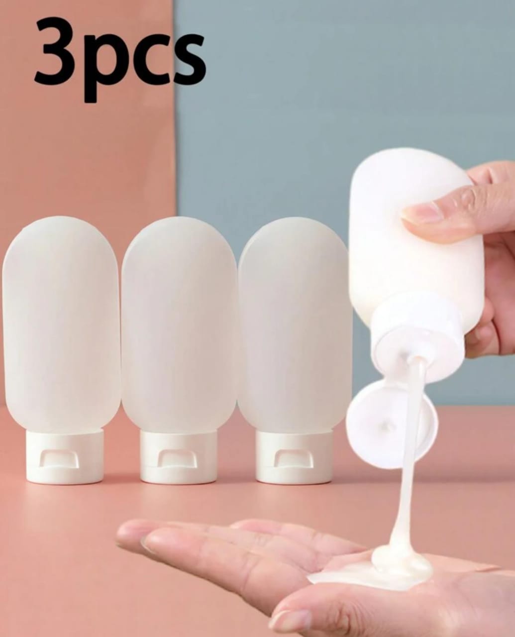 A set of three opaque white squeezable silicone travel bottles with white flip caps, one of which is being squeezed to dispense white lotion into a hand.