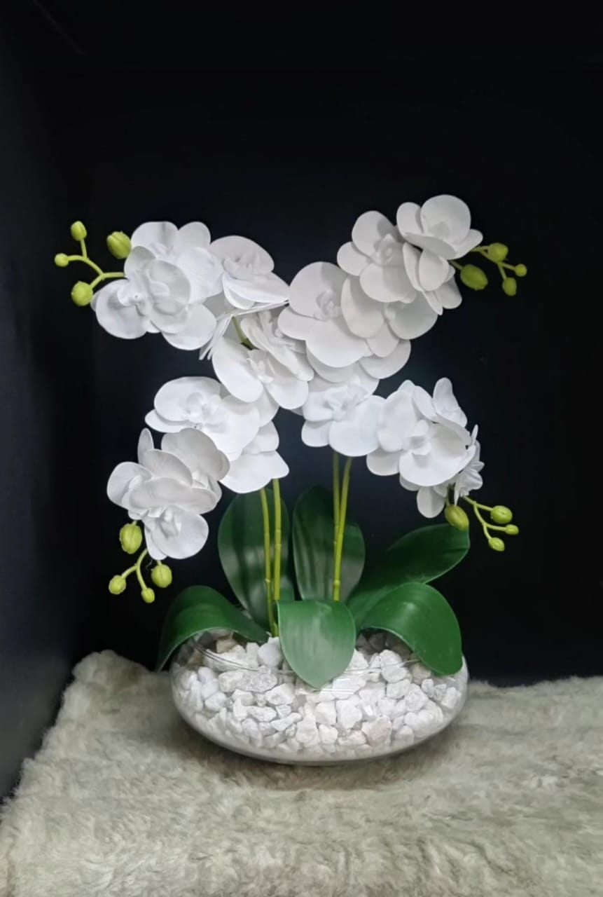 White artificial orchid flowers with green leaves