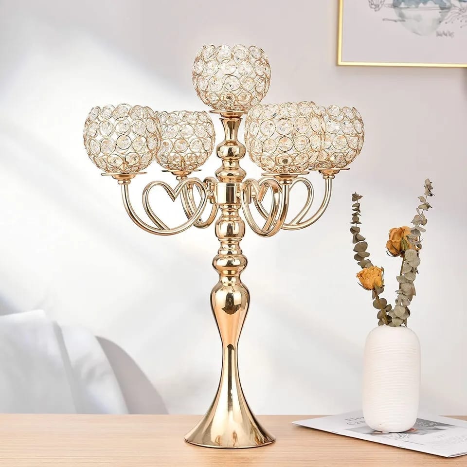 A 25 inch tall gold five arm candlestick with crystal beaded bowls