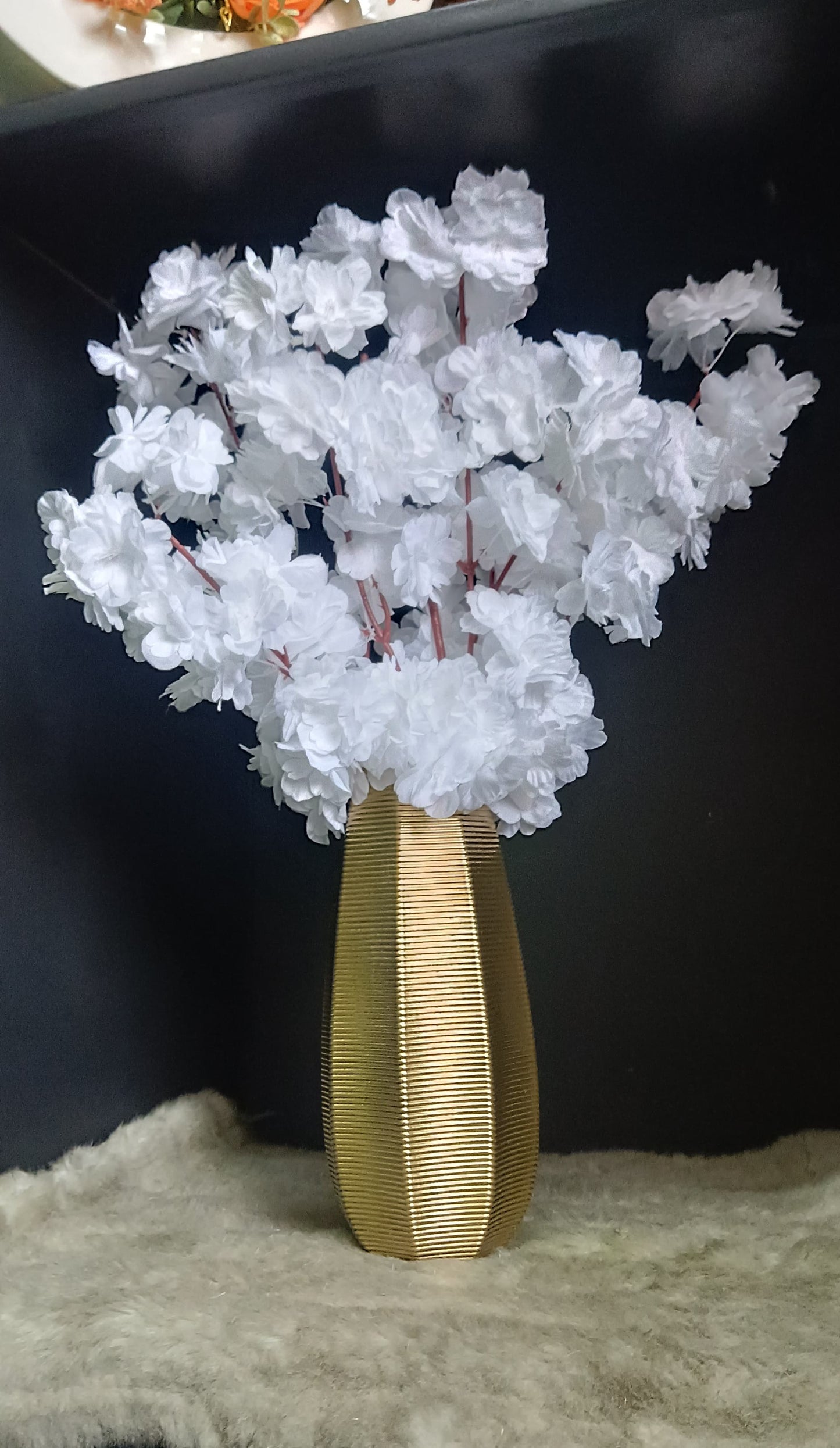 A 40cm clear glass vase filled with pink artificial cherry blossom flowers