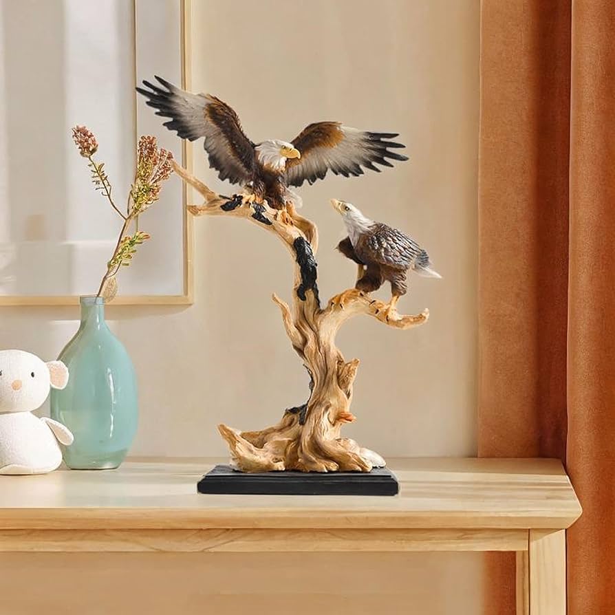 A detailed resin statue of two American eagles perched on a branch with a black base.