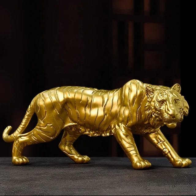 A detailed gold resin tiger statue in a prowling pose.