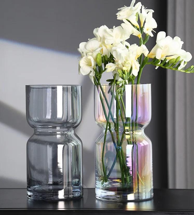 A tall, smoky dark glass vase with a cinched middle design