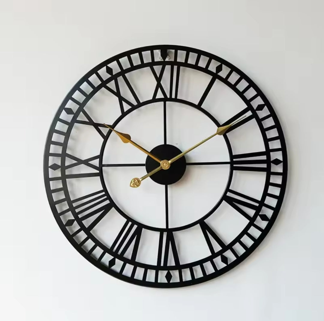 Large 60cm round black metallic wall clock with Roman numerals and gold hands.
