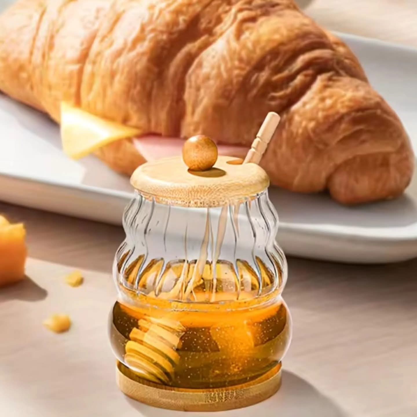 Clear glass beehive honey jar with bamboo lid base and wooden dipper