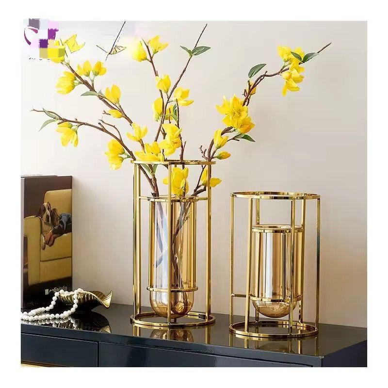 A hand holding a heavy blue glass vase with gold-infused circular line patterns.
