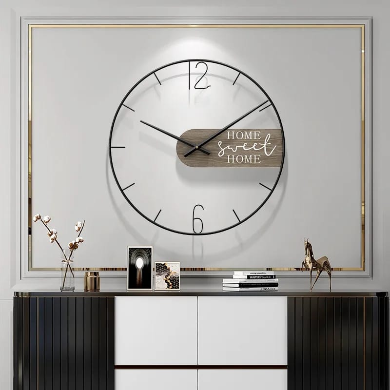 A wall clock with a minimalist design featuring a white bamboo frame and black iron base, with the text 'HOME SWEET HOME' displayed at the top.
