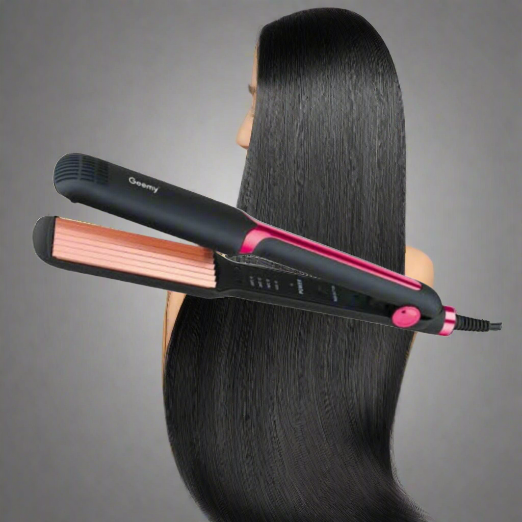 A black and pink hair styling tool with corrugated plates being used to create waves in long, straight black hair.
