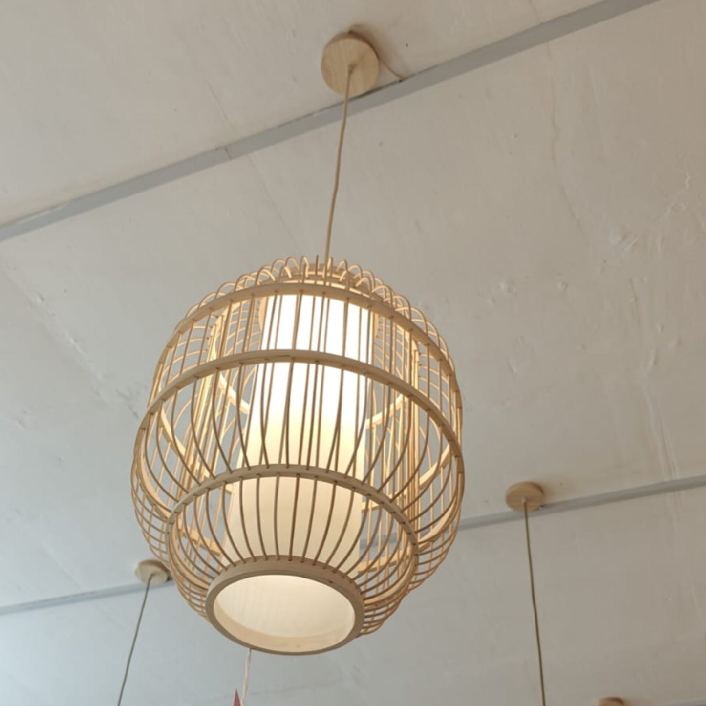 Woven pendant light fixture hanging from a ceiling