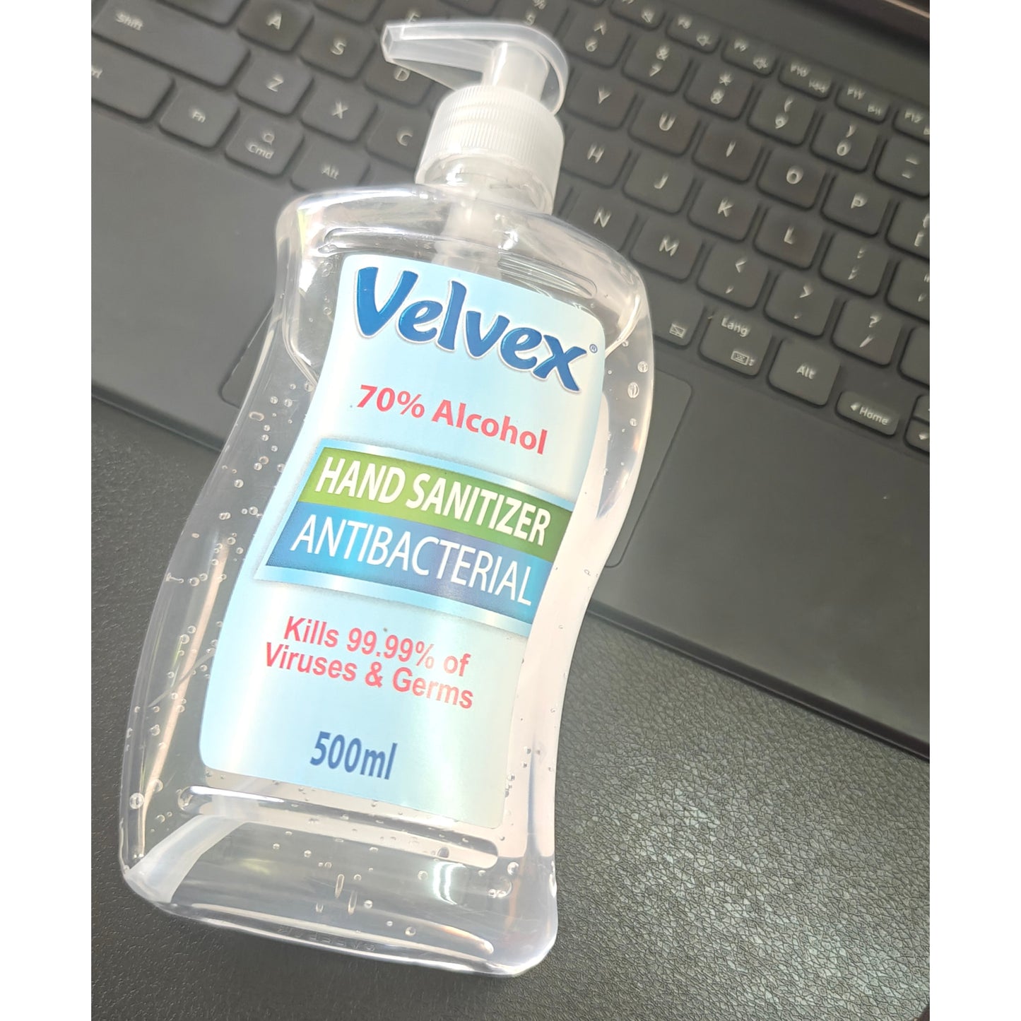 A clear 500 milliliter bottle of Velvex 70% Alcohol Antibacterial Hand Sanitizer with a pump top.