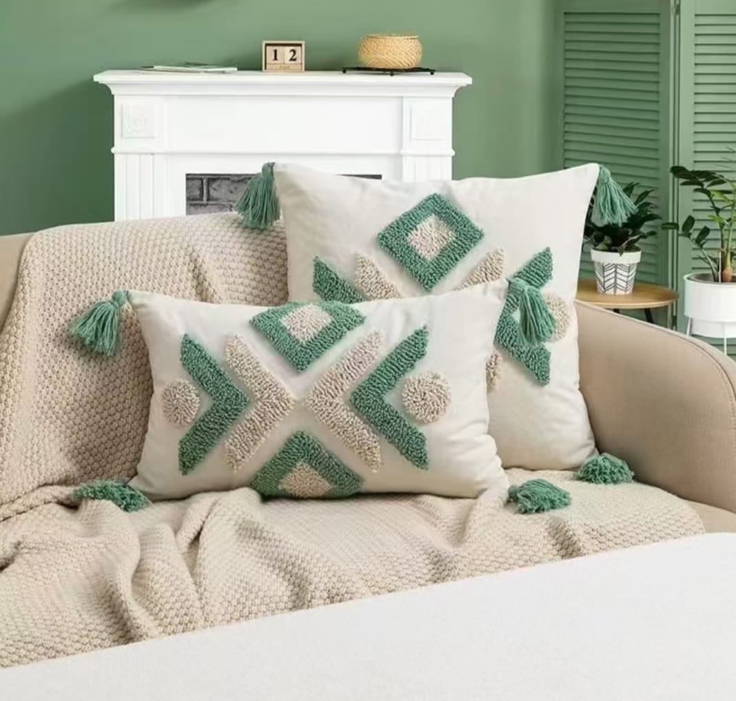 Cream and sage green tufted throw pillows with tassels