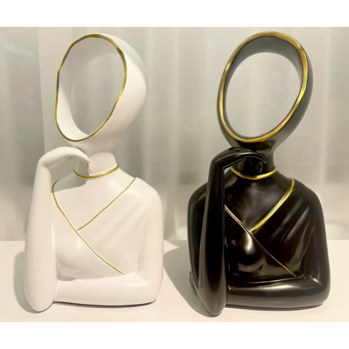 Abstract white and black ceramic figurines with gold trim