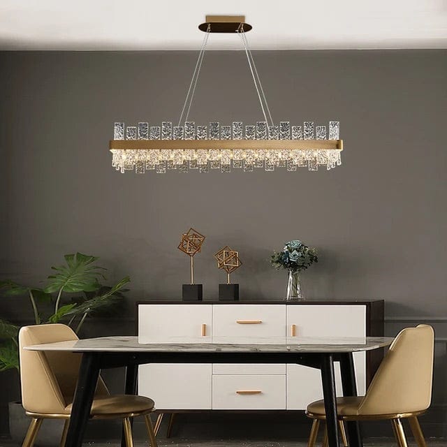 A gold rectangular chandelier with two rows of textured glass blocks.