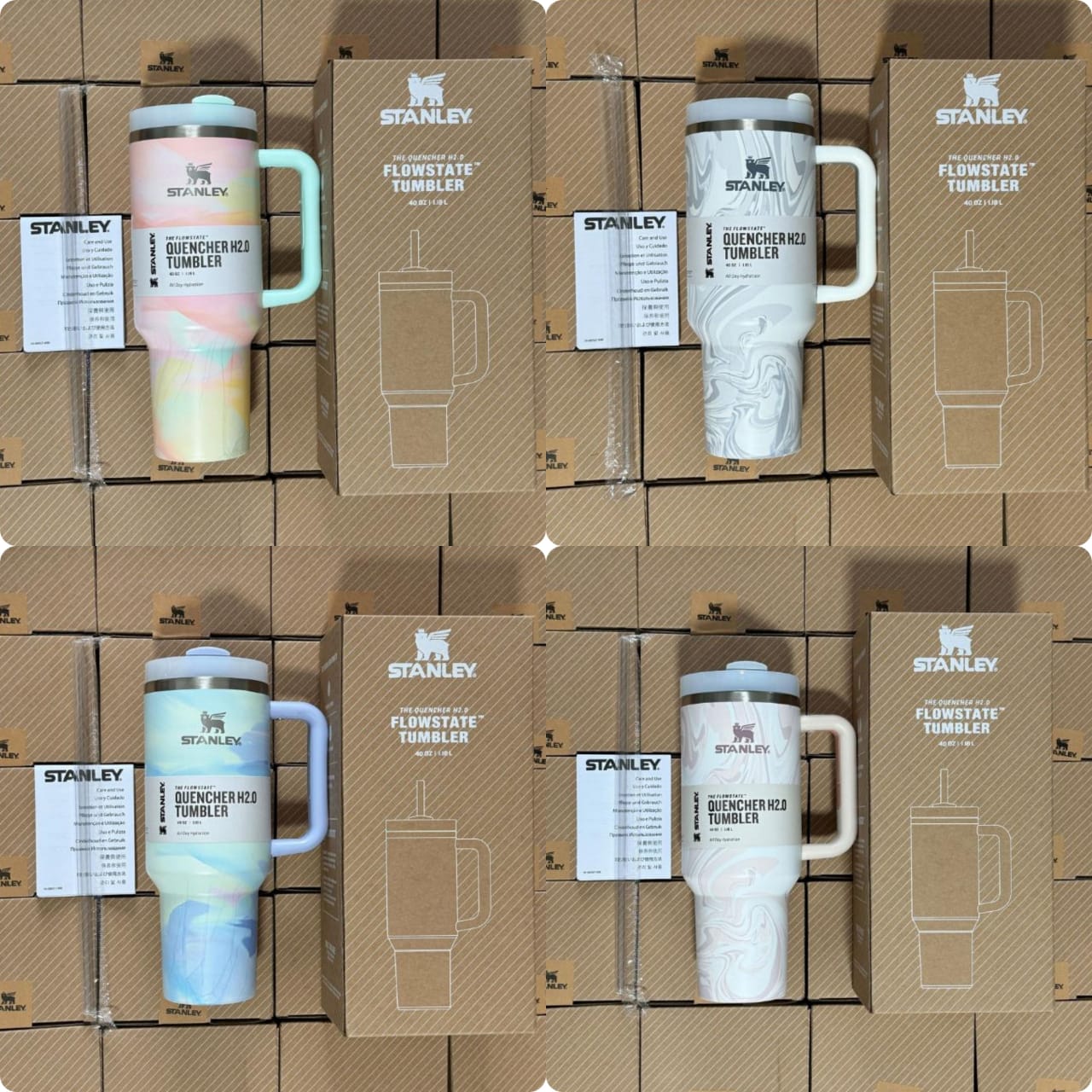 Four Stanley Quencher H2.0 FlowState Tumblers in marble-style finishes, including pastel pink/yellow, grey/white, blue/purple, and light pink, displayed in their original boxes.