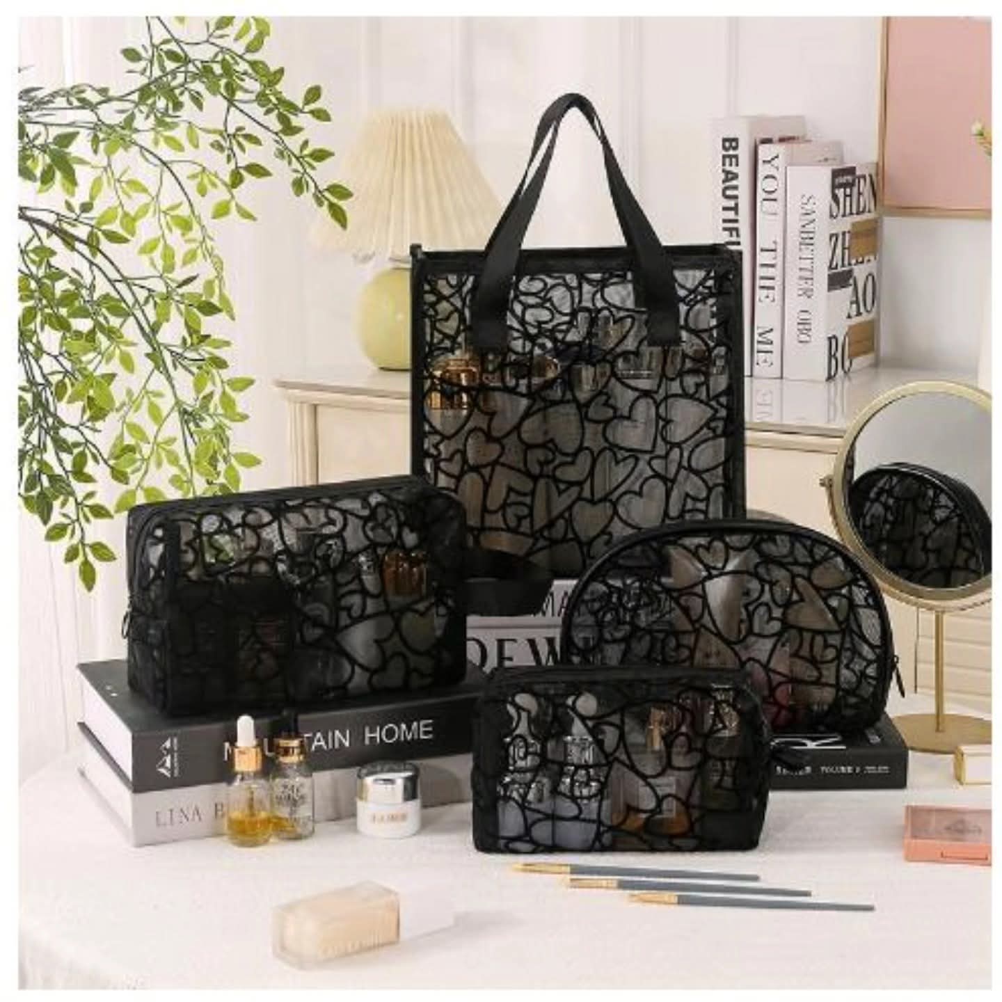 Set of four black heart patterned waterproof travel and cosmetic bags