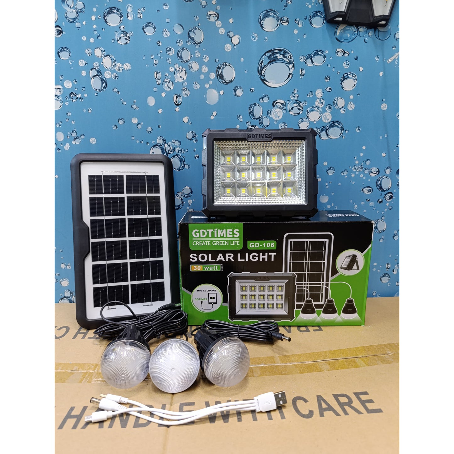 A solar lighting kit featuring a main floodlight, solar panel, three LED bulbs, and a multi head USB charging cable.