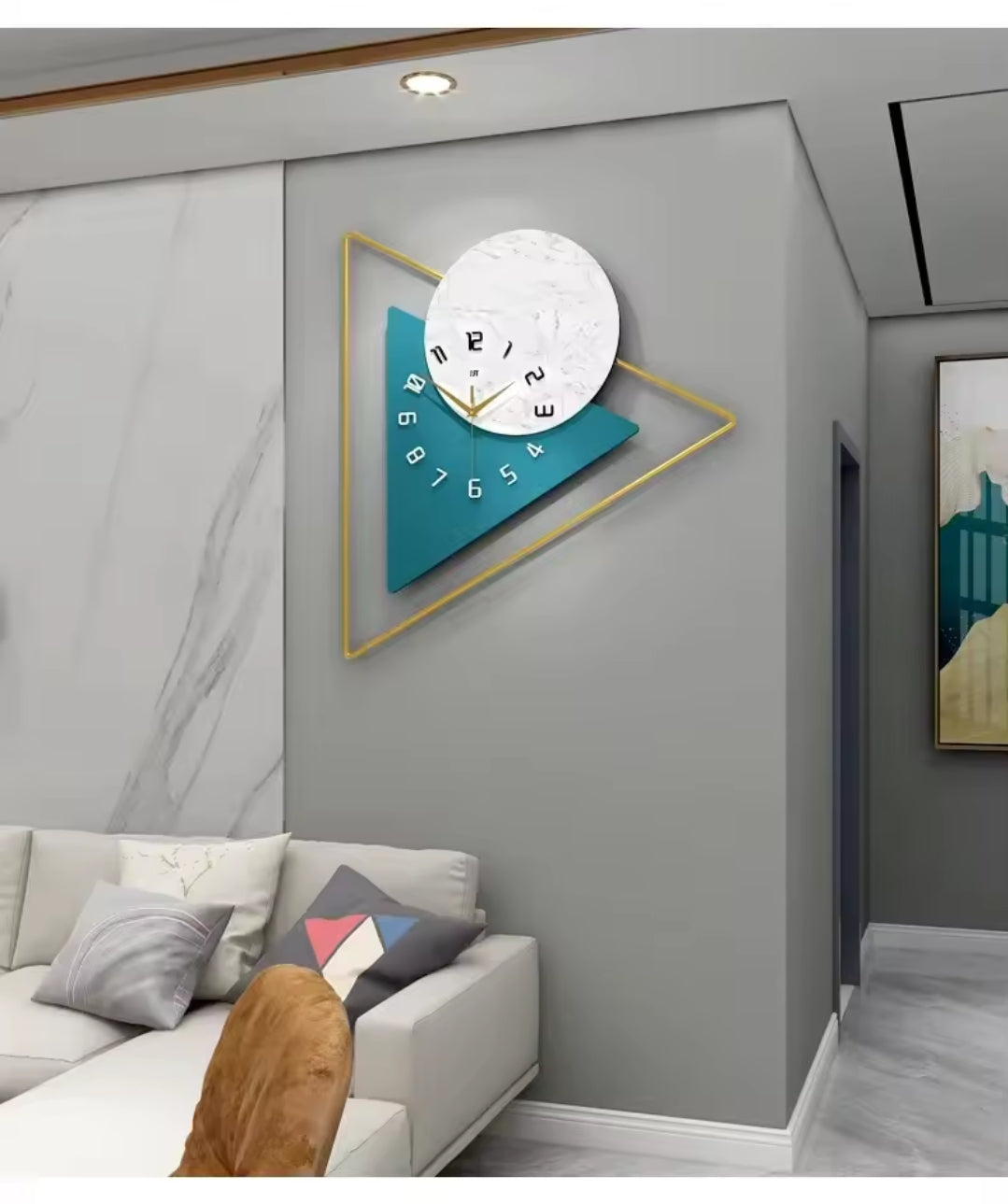 A gold triangular wall clock with a white marble circular dial and a teal triangular background.