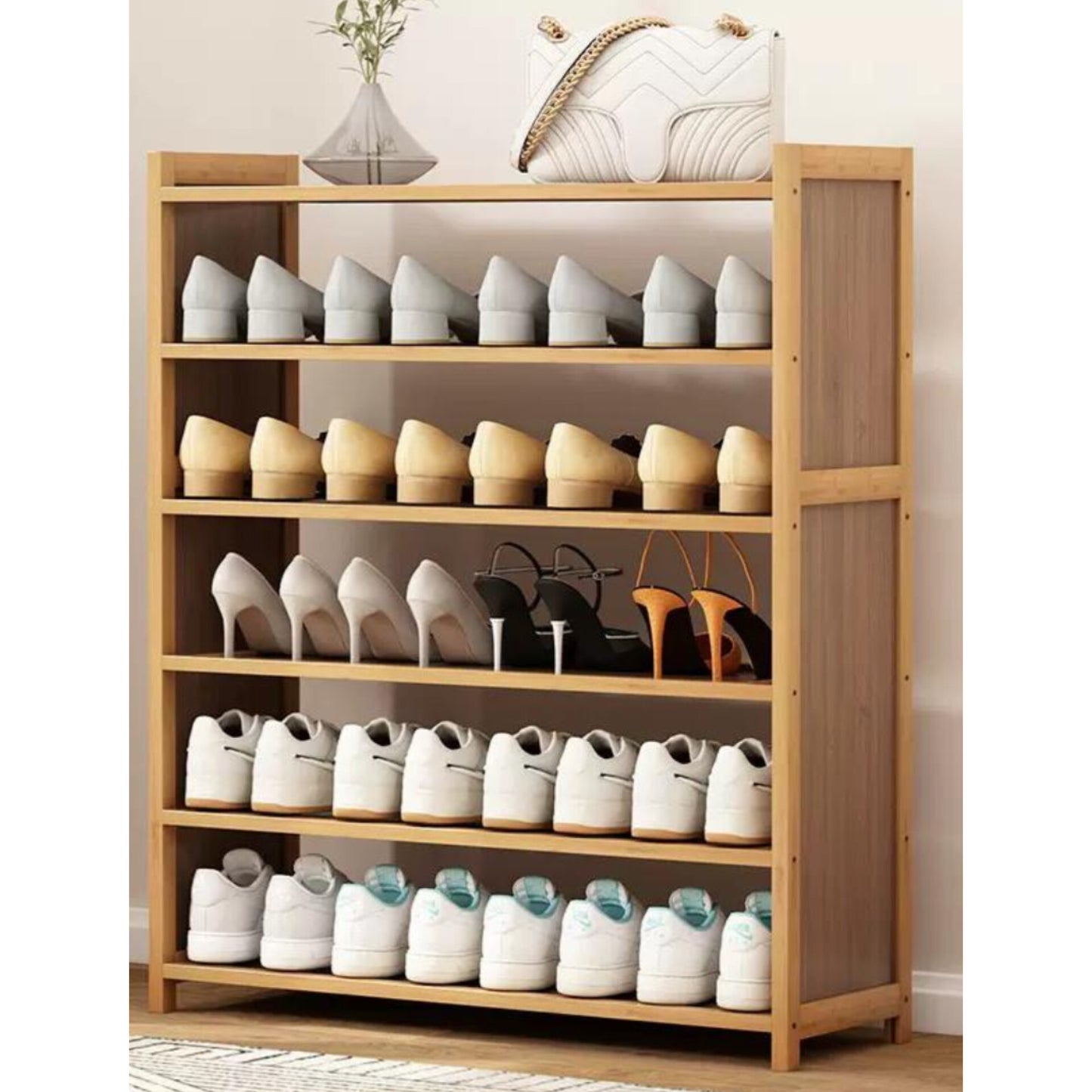 A tall, light brown six tier bamboo shoe rack filled with various styles of shoes.