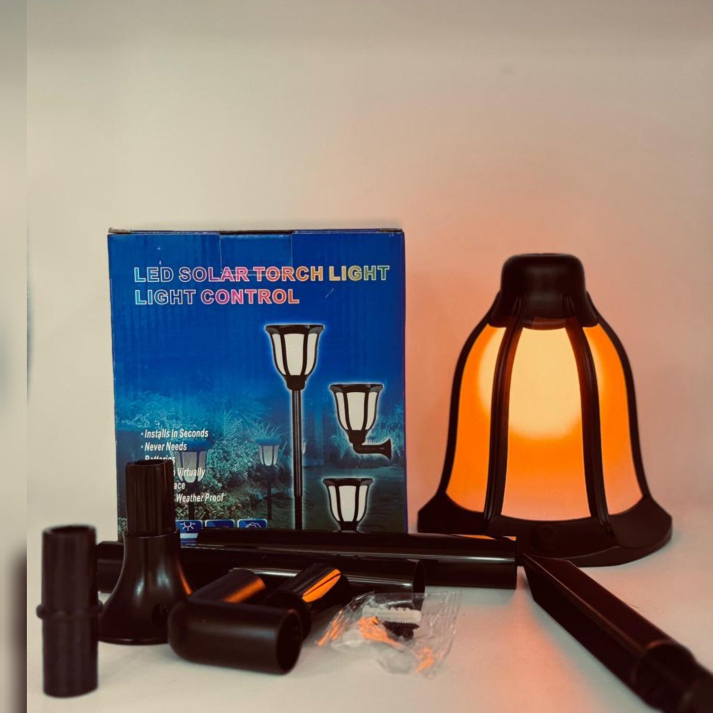 A solar torch light with a glowing orange flame effect.