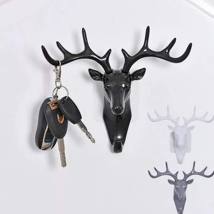 Three molded antelope head key holders in black, white, and gray colors.