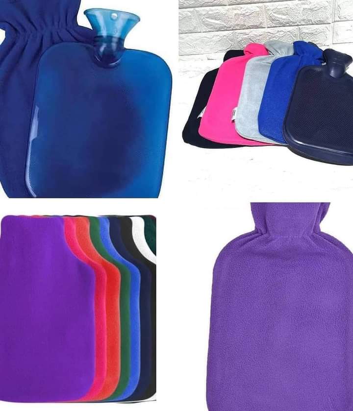 A collection of two-litre hot water bottles in various colors, each with a soft, brightly colored fleece cover, suitable for warmth and pain relief.