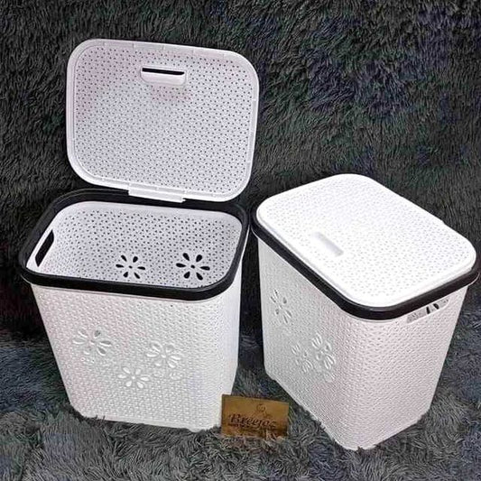 Two white plastic laundry hampers with a basket weave texture and perforated lids.