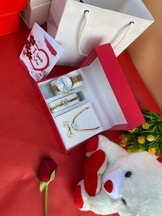A complete 5-in-1 Valentine's gift set featuring a ladies watch, matching necklace, bracelet, and earrings, displayed in a box with a teddy bear, gift bag, and card.