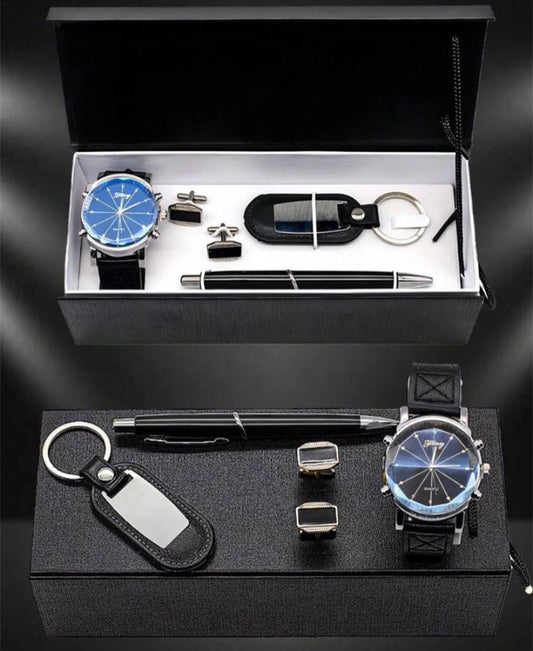 An open black gift box displaying a men's wristwatch with a black strap and blue dial, two pairs of black and silver cufflinks, a black executive pen, and a black leather key holder.