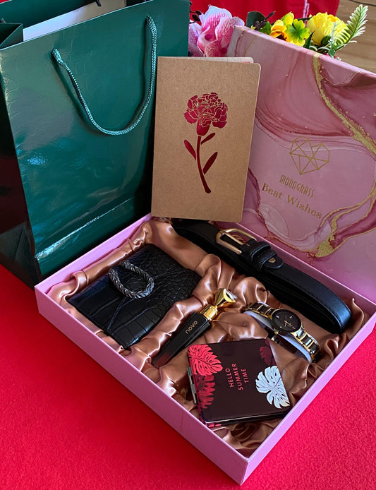 A collection of seven ladies accessories in a gift box, including a watch, perfume, mirror, wallet, purse, and belt, packaged with a card and gift bag.
