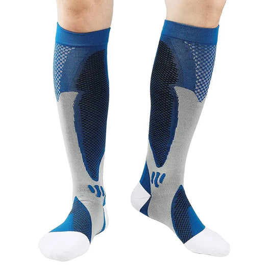 A pair of knee high graduated compression socks in blue, grey, and white worn by a person, showcasing the technical weave pattern.