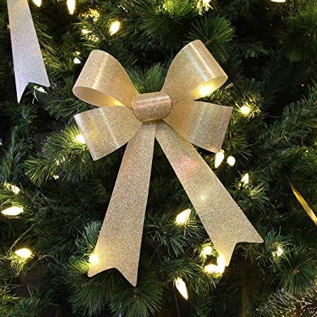 Decorative gold bow with lights on a Christmas tree