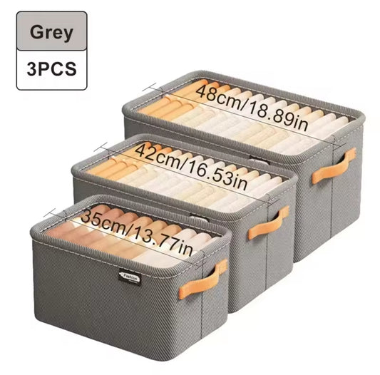 Three gray fabric drawer organizer inserts with wooden dividers and orange handles.
