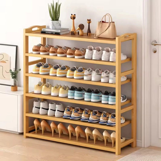 A six tier natural bamboo shoe rack holding multiple pairs of colorful sneakers and high heels.