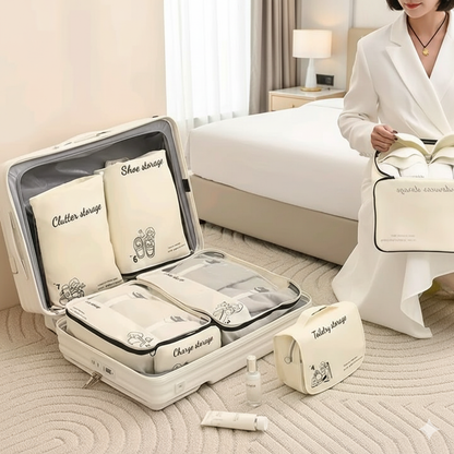 Seven cream colored travel organization bags, including packing cubes, a toiletries bag, and smaller pouches