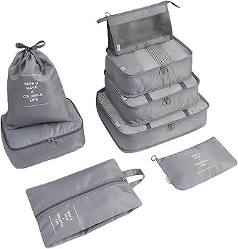 A set of travel organizer cubes including various sizes for packing in a suitcase.