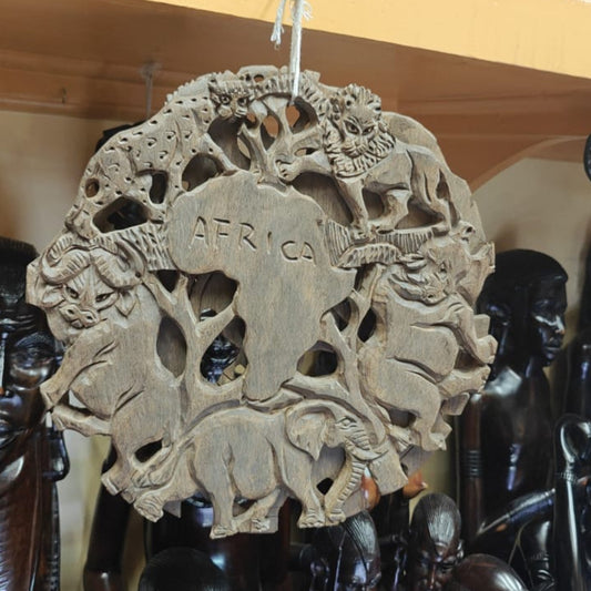 Carved wooden plaque with animals and 'AFRICA' text