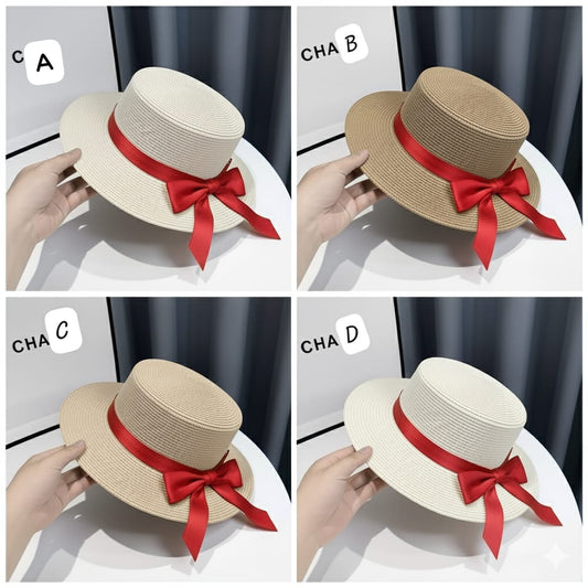 A collage showing four woven summer boater hats in different shades of beige, cream, brown, and white, each adorned with a bright red satin ribbon bow.