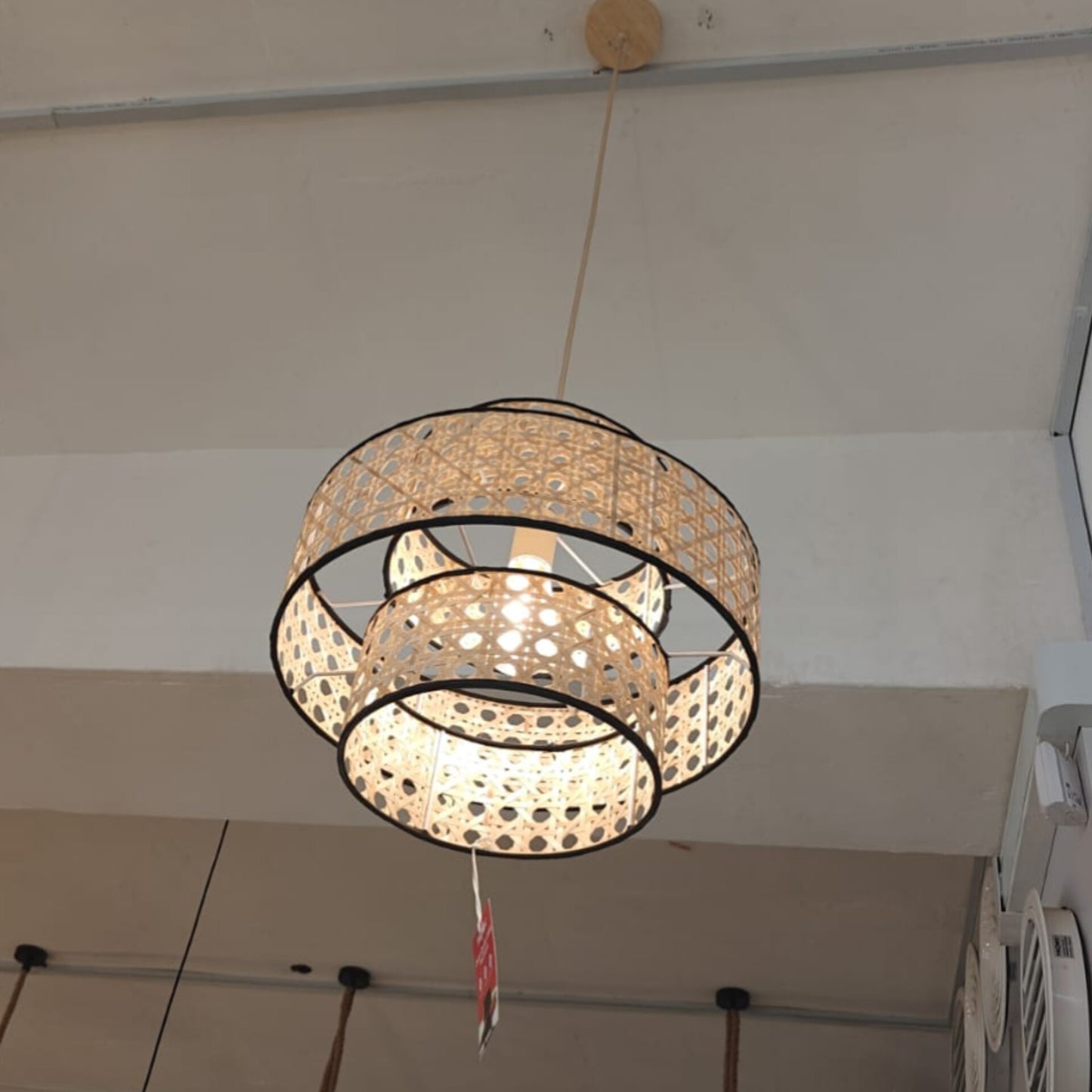 Woven pendant light hanging from a ceiling