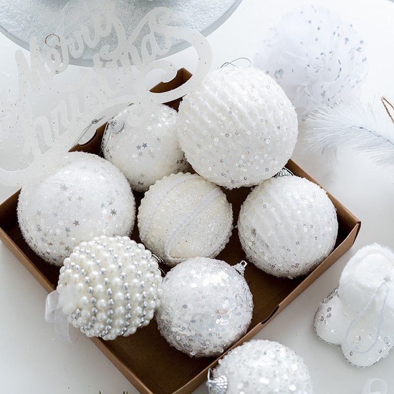 Six large, white, textured Christmas ornaments with glitter, sequins, pearls, and faux fur