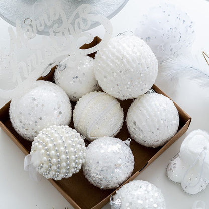 Six large, white, textured Christmas ornaments with glitter, sequins, pearls, and faux fur