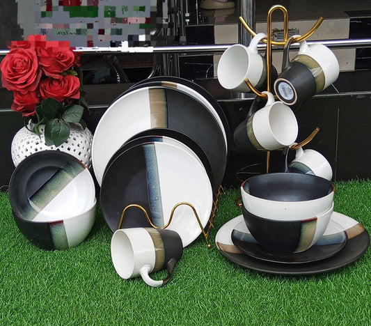 24-piece modern ceramic dinner set featuring abstract black, white, and tan stripes, including dinner plates, side plates, bowls, and mugs.