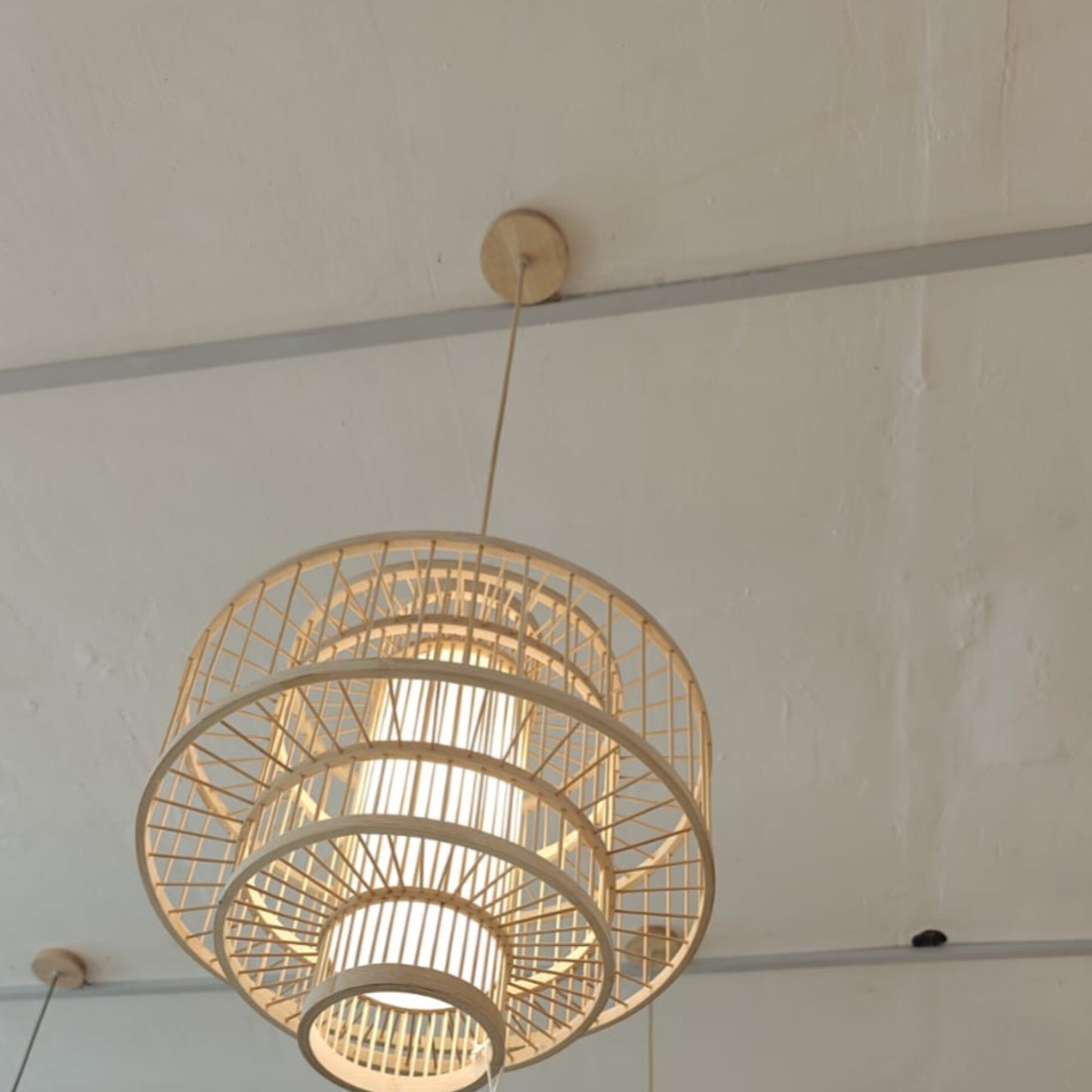 Woven pendant light hanging from a ceiling