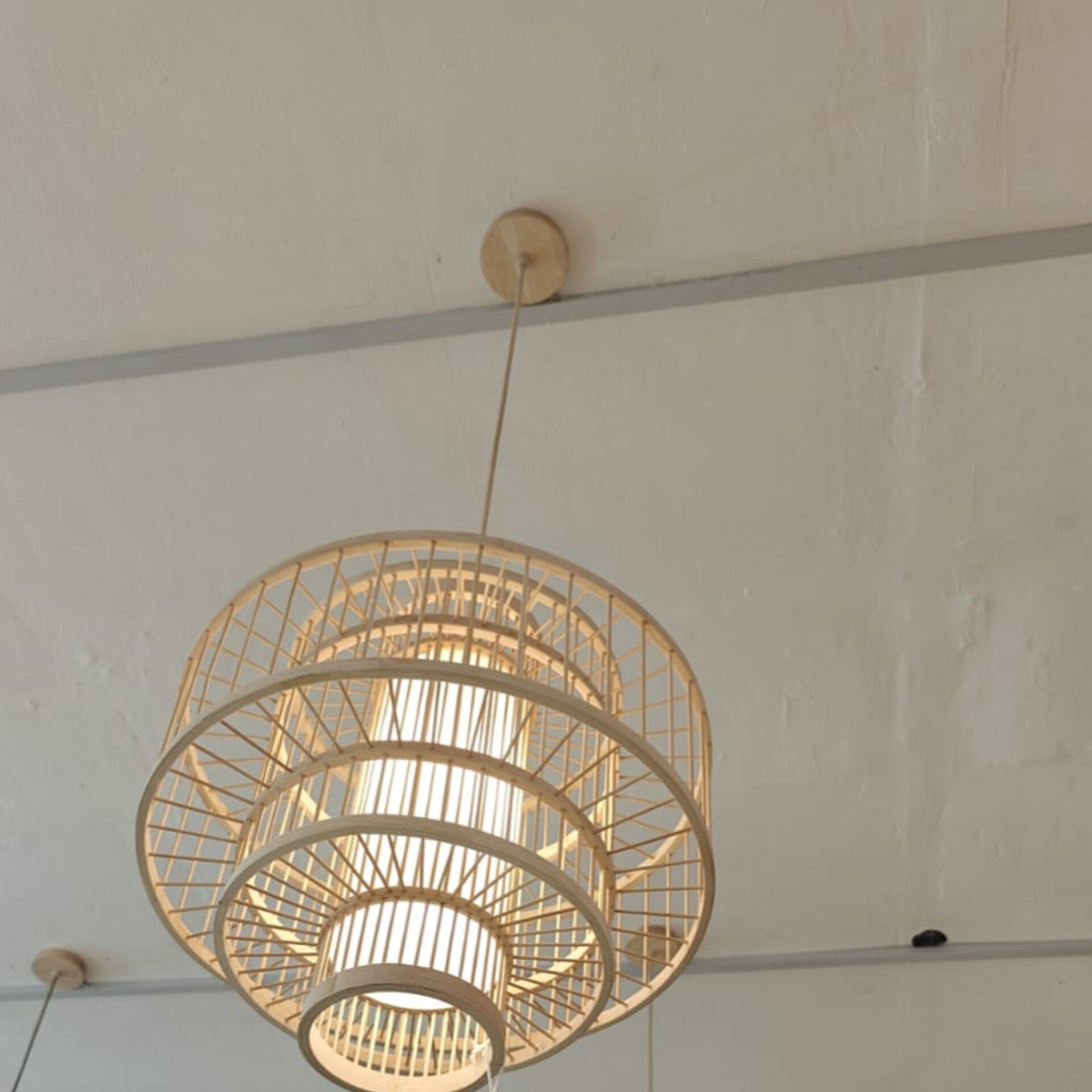 Woven pendant light hanging from a ceiling